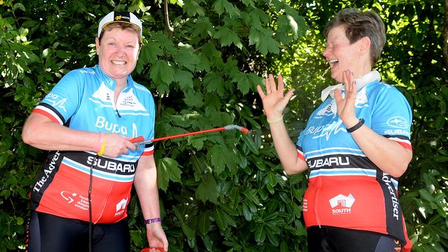 Carol Moore and Michele Bryant did 70km of the cancelled Bupa Challenge Tour, but took extra precautions against the heat. They are using a water mister near Uraidla. Picture: BERNARD HUMPHREYS