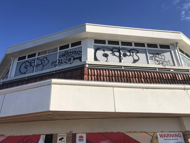 Graffiti vandalism on the top level of the former Sea Life Aquarium building in Manly Cove, Manly, on Tuesday. Picture: Jim O’Rourke