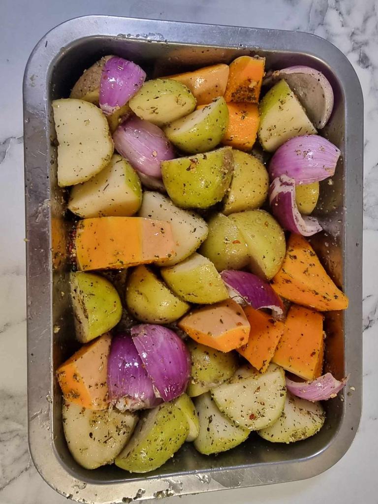 Cooking potatoes, pumpkin and onions in the Ooni pizza oven. Picture: Tahnee-Jae Lopez-Vito/news.com.au.