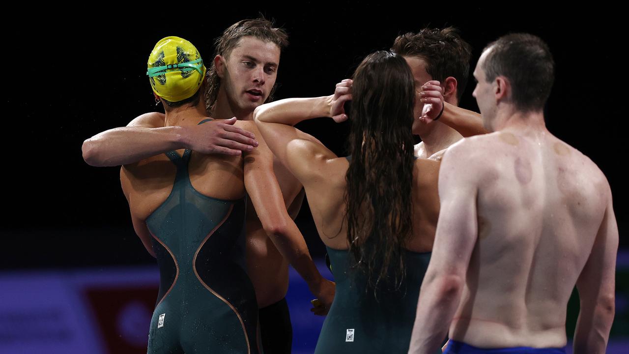 The mixed medley relay team embrace after winning the mixed medley relay. Picture: Michael Klein