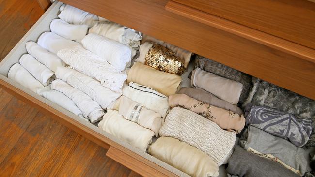 Also, Marie Kondo says you should store your T-shirts like this. And doesn’t an organise wardrobe make you happy? Picture: Troy Snook