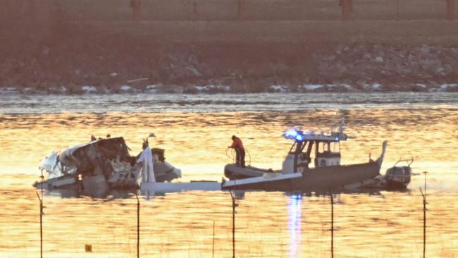 Part of the wreckage is seen as rescue boats search the waters of the Potomac River after the Washington DC air crash. Picture: AFP