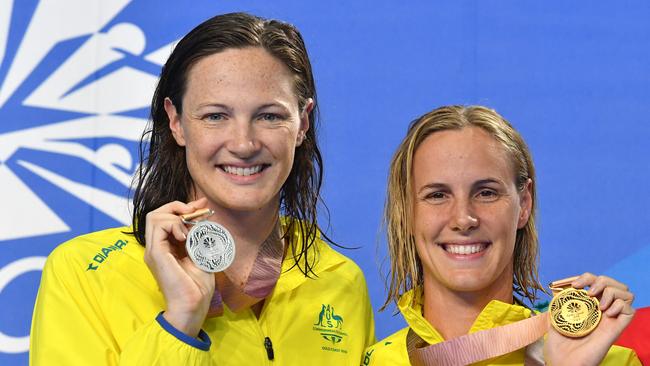 Silver medallist Cate Campbell (left) and her sister gold medallist Bronte Campbell (right) during the medal ceremony for the Womens 100m Freestyle Final at the 2018 Commonwealth Games at Gold Coast Aquatic Centre. (AAP Image/Darren England)