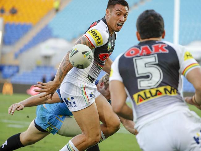 Dean Whare of the Panthers (left) passes the ball during the Round 22 NRL match between the Gold Coast Titans and the Penrith Panthers at Cbus Super Stadium on the Gold Coast, Saturday, August 11, 2018. Picture: AAP Image/Glenn Hunt