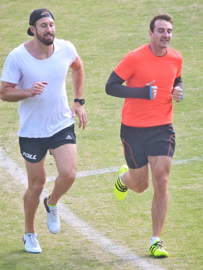 Jobe Watson (right) warms up with Cale Hooker. Picture: Hamish Blair