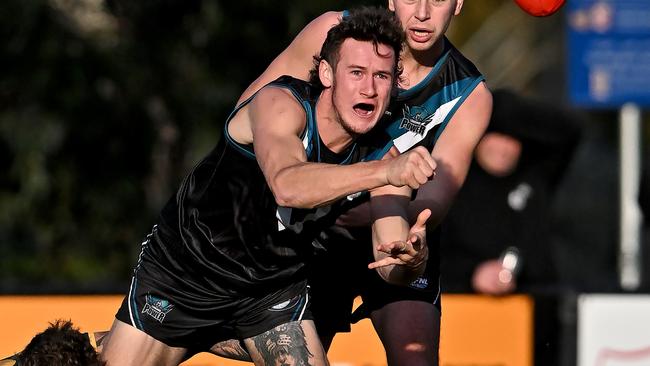 Laurimar’s Jake Richards handballs out of trouble. Picture: Andy Brownbill