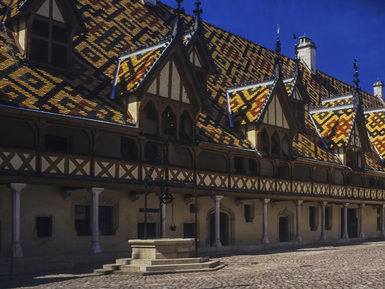 The hospice at beaune in the cote d'or department of Burgundy, France, Multi-coloured roof tiles. Picture: istock