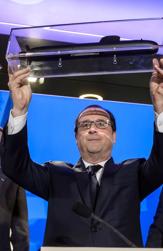 Crowning moment ... French President Francois Hollande holds up a model submarine at DCNS headquarters in Paris, France.