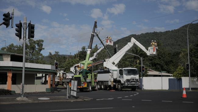 Ergon Energy crew conduct repairs on power lines following a two-vehicle collision at the intersection of Enmore St and Reservoir Rd, Manoora with a sedan careering into a power pole, about 12am, July 3. Picture: Arun Singh Mann