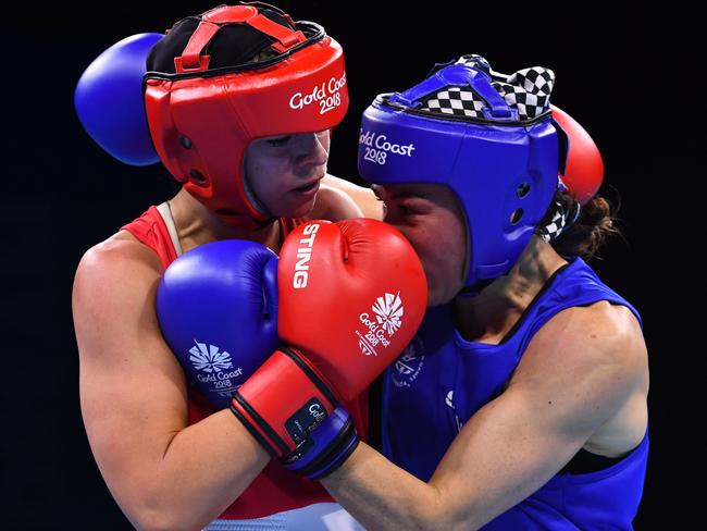 Australia's Skye Nicolson (L) fights with Canada's Sabrina Aubin-Boucher during their women's 57kg semi-final boxing match during the 2018 Gold Coast Commonwealth Games at the Oxenford Studios venue on the Gold Coast on April 13, 2018. / AFP PHOTO / Anthony WALLACE