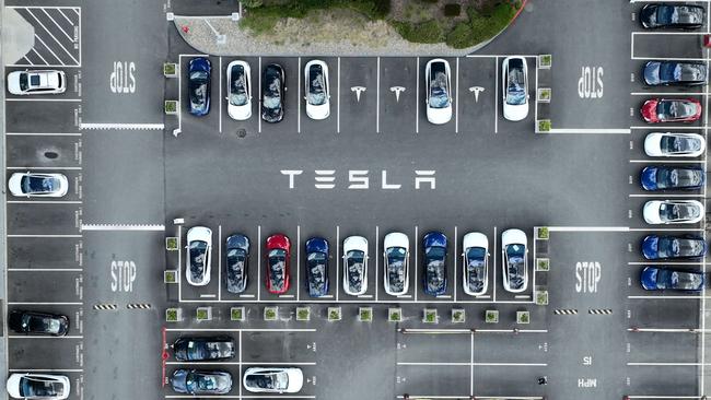 Tesla cars sit parked in a lot at a factory in California. The company has reported a surge in profits though there are signs of a bumpier road ahead. Picture: Justin Sullivan/Getty Images/AFP