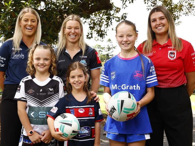 DAILY TELEGRAPH NOVEMBER 18, 2024. From left junior players Maddison Dolton, 9, Airlie Borg, 8, and Ella Brightwell, 12, with Bulldogs inaugural signing Tayla Preston, Sharks Emma Verran and Newcastle born Dragons player Bobbi Law during the announcement at the Domain Sydney, of the inaugural NRLW Magic round in Newcastle next season. Picture: Jonathan Ng