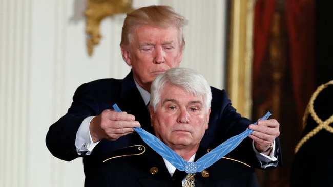 Donald Trump awards the Medal of Honour to James McCloughan at the White House in 2017. Picture: AP