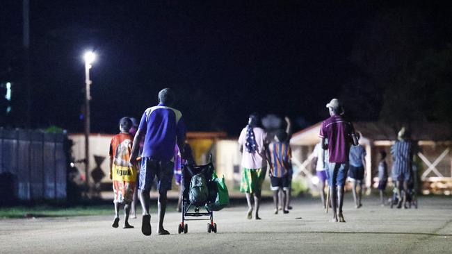 A family walks down the main street of Aurukun, a small Indigenous town on The Gulf of Carpentaria, 800 kilometres north northwest of Cairns on Cape York in Far North Queensland. Picture: Brendan Radke