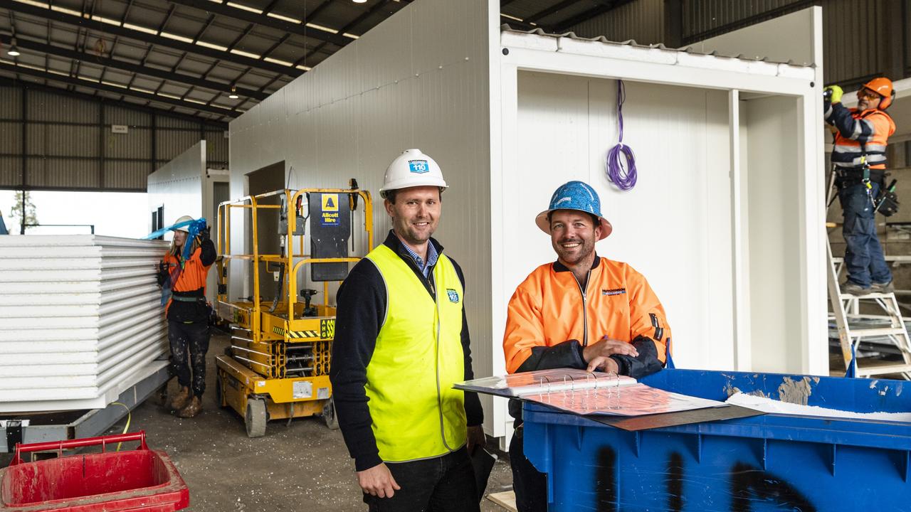 Hutchinson Builders construction manager Gavin Taylor (left) and projects manager Rian Cherry as the Toowoomba business unit construct modular housing to support flood victims in Lismore. Picture: Kevin Farmer