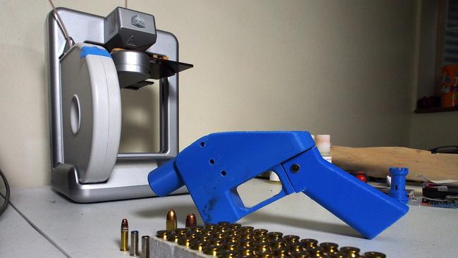 (FILES) In this file photo taken on July 17, 2013 a Liberator pistol appears next to the 3D printer on which its components were made in Hanover, Maryland. US President Donald Trump said on July 31, 2018 he was 