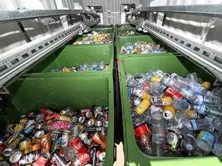 Deposited bottles are stacked into bins at the rear of the 'Return and Earn' recycling station. Picture: Tweed Daily News