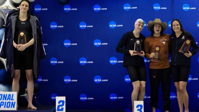 Lia Thomas, left, of the University of Pennsylvania stands on the podium after winning the 500-yard freestyle as other medallists Emma Weyant, Erica Sullivan and Brooke Forde pose for a photo. Picture: Justin Casterline/Getty Images