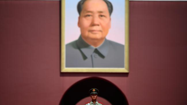 A paramilitary policeman stands in front of a portrait of late communist leader Mao Zedong at Tiananmen Gate in Beijing. Picture: AFP