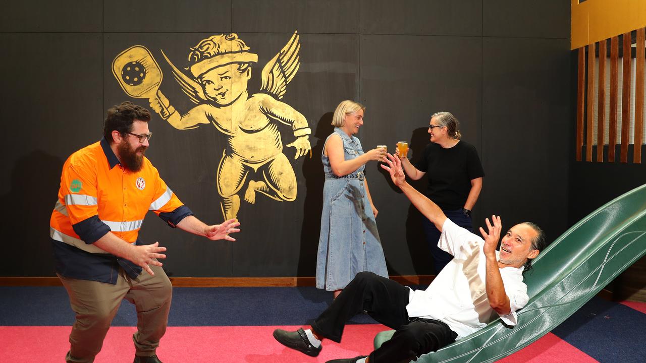 Little Creatures brewing leader Dennis Stewart, venue manager Olivia Hosking, left, national hospitality operations manager Carrie Watson and executive chef Stephen Shing trying out the kids slide inside the multimillion dollar revamped South Geelong premises. Picture: Alison Wynd