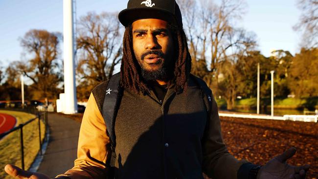 Lumumba speaking to reporters at Collingwood in 2013.