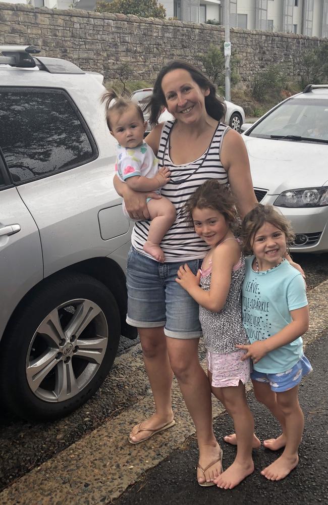 The Cannon Family, from Freshwater, waiting patiently in the COVID testing line at the pop-up clinic in Manly, with three children under the age of eight. Mum Lizzie is holding Ava, 10 months, with Bethany, 7, and Ella, 5. Picture: Jim O'Rourke.