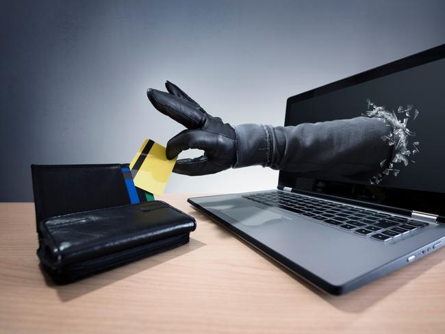 Stealing a credit card through a laptop concept for computer hacker, network security and electronic banking security