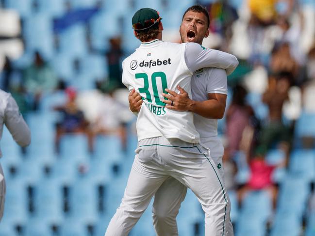 South Africa's Dane Paterson (2nd R) celebrates with teammate South Africa's Tristan Stubbs (2nd L) after the dismissal of Pakistan's Aamer Jamal (unseen) during the third day of the first cricket Test match between South Africa and Pakistan at SuperSport Park in Centurion on December 28, 2024. (Photo by PHILL MAGAKOE / AFP)