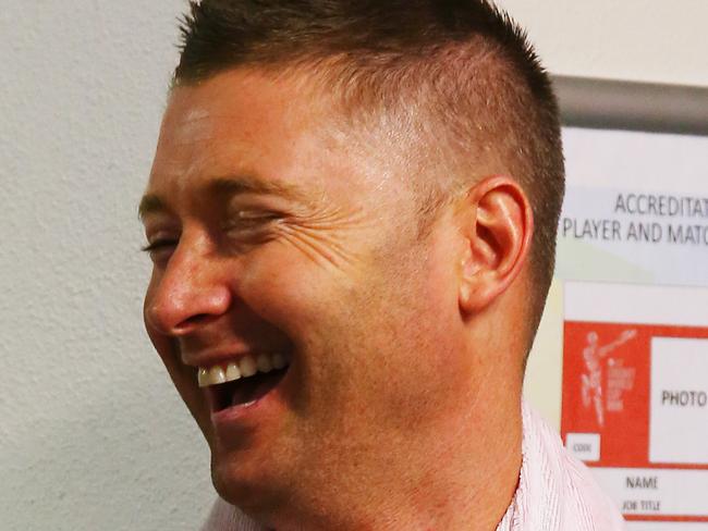 Australia's Michael Clarke smiles as he waits in the grandstand ahead of their Cricket World Cup match against Bangladesh being abandoned due to weather in Brisbane, Australia, Saturday, Feb. 21, 2015. (AP Photo/Tertius Pickard)