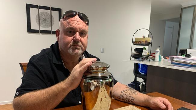 Brett Beasley, with his sons ashes at their family home.