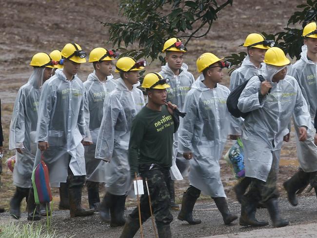 Rescuers walk toward the entrance to the cave complex. Picture: AP Photo/Sakchai Lalit