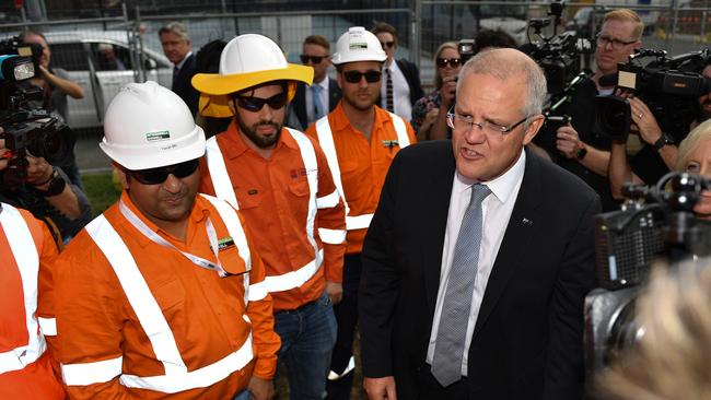 Scott Morrison is surrounded by hi-vis vests at the corner of Mulgoa and Castlereagh St at Penrith.Picture: AAP