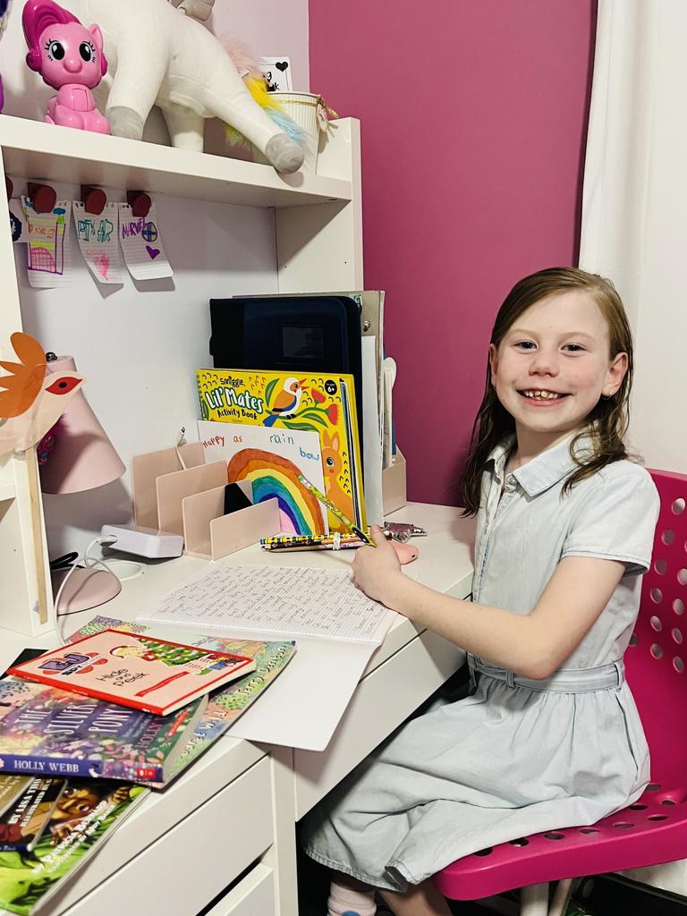 Competition winner Georgie Bozhoff, 7, from Augustine Heights near Ipswich in Queensland, won the K-2 category with her story The Cheese Moon and loves writing in her "peaceful" bedroom. Picture: supplied