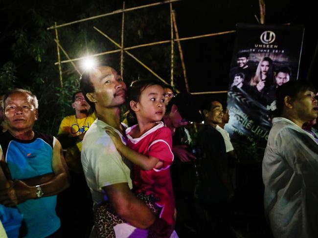 Onlookers watched and cheered as ambulances transport some of the rescued schoolboys from a helipad to hospital. Picture: Getty Images