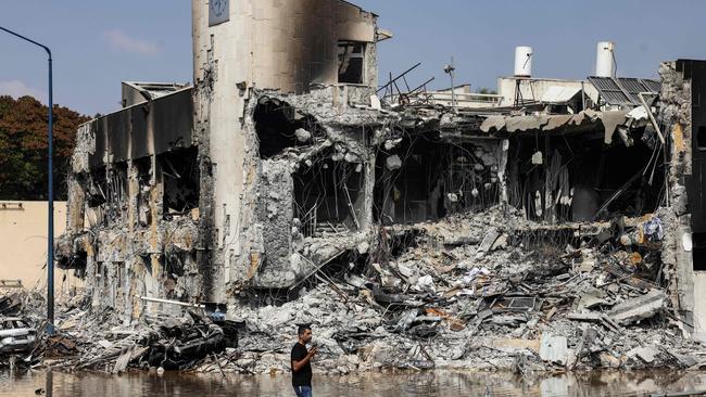 A man walks past an Israeli police station in Sderot after it was damaged during battles to dislodge Hamas terrorists.