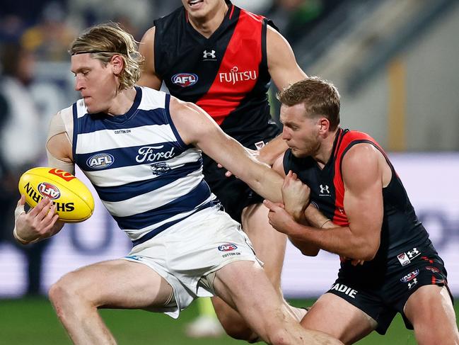 GEELONG, AUSTRALIA - JULY 15: Mark Blicavs of the Cats is tackled by Darcy Parish of the Bombers during the 2023 AFL Round 18 match between the Geelong Cats and the Essendon Bombers at GMHBA Stadium on July 15, 2023 in Geelong, Australia. (Photo by Michael Willson/AFL Photos via Getty Images)