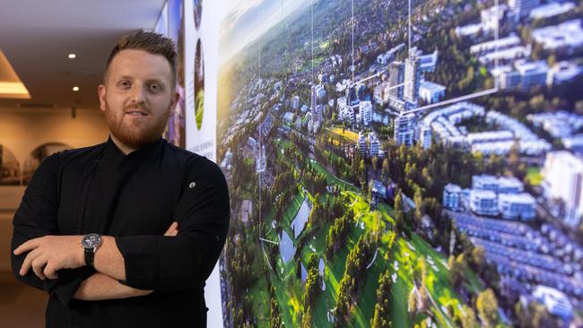 Joshua Mason in front of display plans for Opera at Norwest. Picture: Monique Harmer