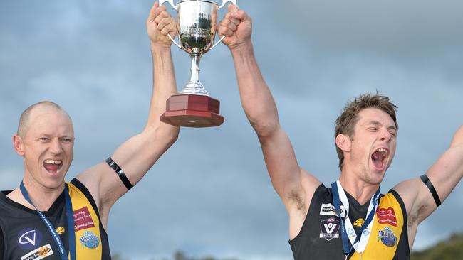 Danny Ryan and Brendan Sneddon raise the 2014 premiership trophy. Picture: Lawrence Pinder