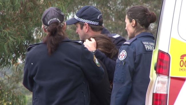 The grandmother of a five-year-old boy stabbed to death in his Carlingford home this morning is comforted by police and paramedics. Picture: TNV