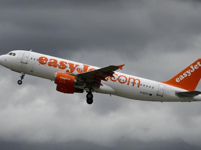 (FILES) This file photo taken on May 19, 2015 shows an Airbus plane of British low cost airline EasyJet taking off under heavy clouds in Geneva. Airlines are facing one of their most challenging periods "for a long time", with peak summer bookings hit by terror attacks and Brexit uncertainty, the boss of EasyJet said on July 21, 2016. / AFP PHOTO / FABRICE COFFRINI