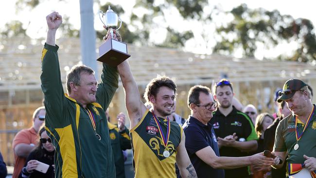 Marion coach Ben Porter and captain Stephen Saunders lift the trophy. Picture: AAP/ Bianca De Marchi