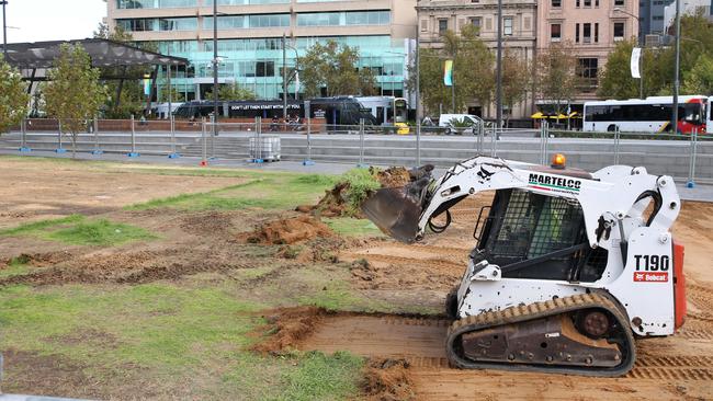 A worker removes damaged turf in Victoria Square after the Royal Croquet Club packed up. Picture: Stephen Laffer