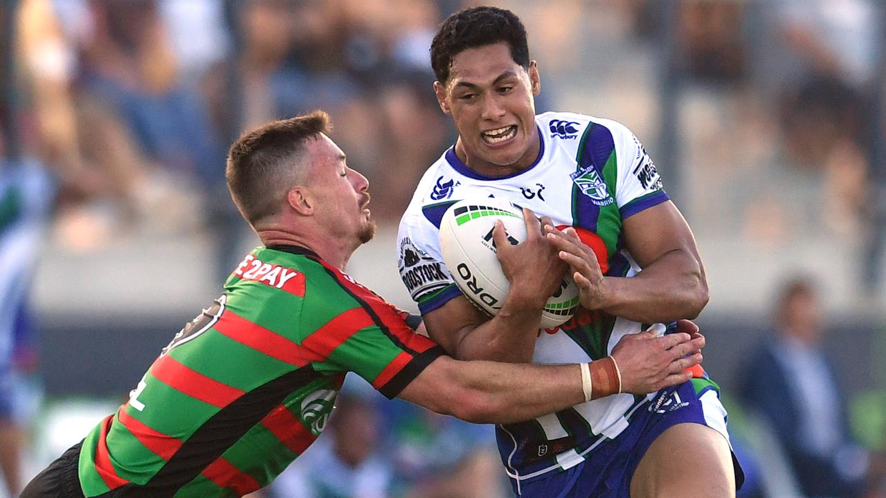 Roger Tuivasa-Sheck (right) of the Warriors is tackled by Damien Cook (left) of the Rabbitohs.