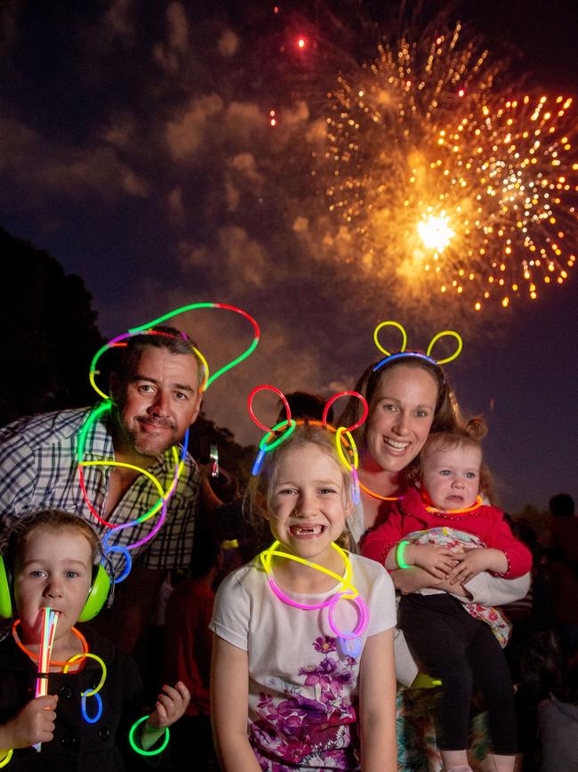 Jamie and Joanne Wilson and their kids Erica, 7, Ashleigh, 4, and Georgia, 16 months, at Yarra Park. Picture: Jay Town