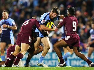 SYDNEY, AUSTRALIA - MAY 03: Dean Britt of the NSW is tackled by Brenko Lee and Kierran Moseley of QLD during the Under-20s State of Origin match between the New South Wales Blues and the Queensland Maroons at Sportingbet Stadium on May 3, 2014 in Sydney, Australia. (Photo by Brendon Thorne/Getty Images)