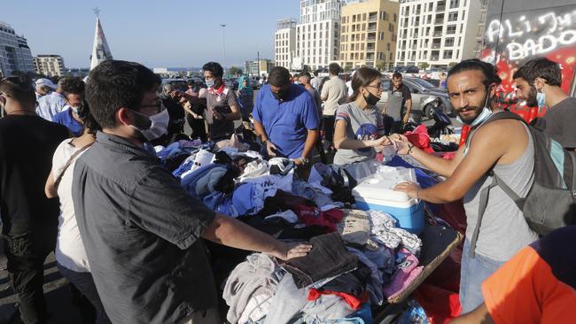 People collect donated items in Martyrs Square to help those affected by the devastating explosion. Picture: Getty Images