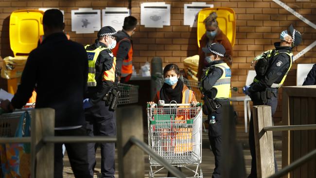 Food and essentials are distributed at a locked down North Melbourne housing block. Picture: Getty Images