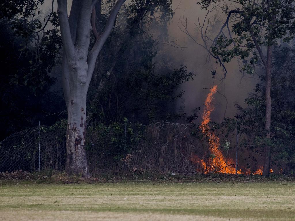 Smoke haze covers the Gold Coast Skyline from a grass fire at Carrara. Emergency services at St Michael's Collage, Merrimac. Fire burning near the school oval. Picture: Jerad Williams