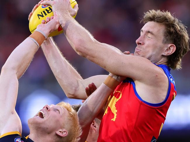 ADELAIDE, AUSTRALIA - MAY 12: Harris Andrews of the Lions marks the ball over Elliott Himmelberg of the Crows during the 2024 AFL Round 09 match between the Adelaide Crows and the Brisbane Lions at Adelaide Oval on May 12, 2024 in Adelaide, Australia. (Photo by Sarah Reed/AFL Photos via Getty Images)