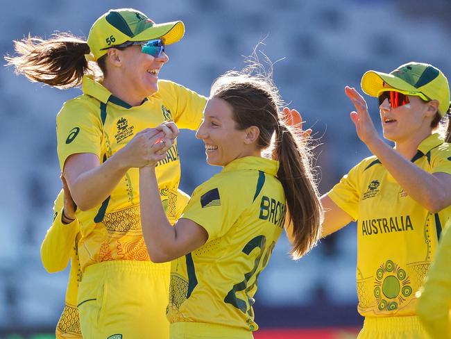 Australia's Darcie Brown (2nd L) celebrates with teammates after the dismissal of India's Richa Ghosh (not seen) during the semi-final T20 women's World Cup cricket match between Australia and India at Newlands Stadium in Cape Town on February 23, 2023. (Photo by Marco Longari / AFP)